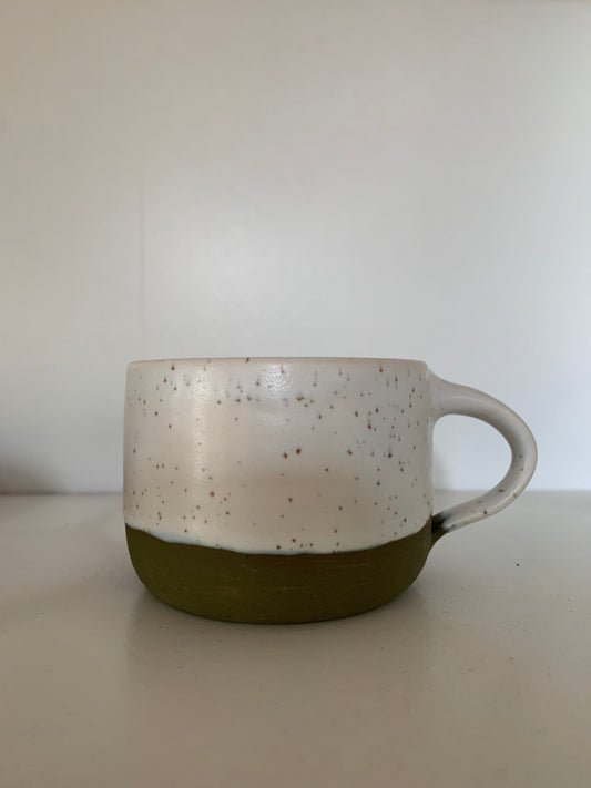 Green and white speckled mug